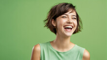 A Woman Smiling And Wearing A Green Shirt And Green Tank Top With A Green Background