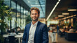 © ArturSniezhyn - Portrait of a successful businessman against the backdrop of an office, beautiful lighting.