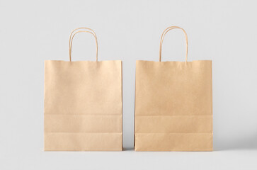 Wall Mural - Kraft paper bag with handles, blank mockup isolated on a grey background.