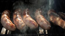 Close Up View Of Grill Sausage On A Charcoal Barbecue Grill With A Fire. Slow Motion View