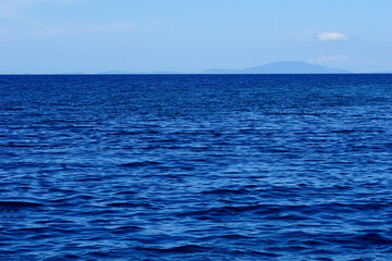 Far sea horizon with moody sky and wavy sea surface