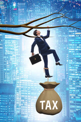 Canvas Print - Businessman hanging on tree branch