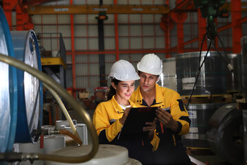 Wall Mural - worker or engineer working in factory with safety uniform , safety hat and safety glasses , image is safety concept or happy workplace