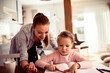 © Vorda Berge - Loving young mother doing homework with her daughter at home