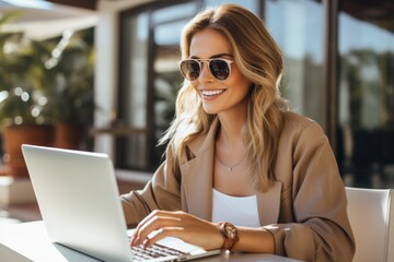 Wall Mural - Woman with a laptop. The concept of remote work or freelancing. Portrait with selective focus