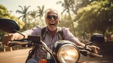 Fototapeta  - A Happy elderly man enjoying a road trip, adventure driving a motorbike on a road covered with tall trees.
