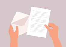 A Person’s Hand Opening A Letter From An Envelope. Close-Up.