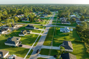Sticker - Aerial view of street traffic with driving cars in small town. American suburban landscape with private homes between green palm trees in Florida quiet residential area