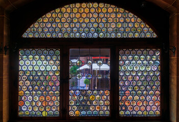 Sticker - Bottle bottom stained glass window in a half timbered house, Strasbourg, France