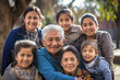 © Anoo - Mexican or Hispanic family together. Family photo of grandfather with grandchildren. Grandchildren visit elderly parents. Family values. Caring for the elderly.