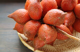 Clusters of Fresh Ripe Salak or Snakeskin Fruit in a Basket