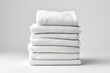 A stack of folded white towels on a table. AI image.