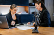 © Vladislav - A female lawyer at her workplace communicates with a young client, discussing issues of legal significance. Consultation concept with legal and financial issues