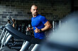 © zorandim75 - Healthy young man in GYM running on treadmill