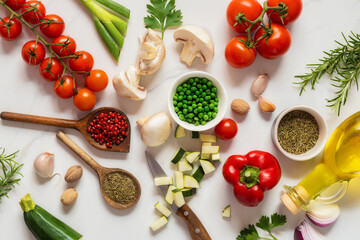Poster - Healthy food cooking ingredients background with fresh vegetables, herbs, spices and olive oil on marble table top view