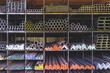 Group of various types of steel bars and pipes stacked on the storage shelf of building materials supply store
