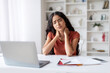 © Prostock-studio - Weary young indian woman working on laptop at home office