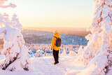 Fototapeta Do pokoju - Young woman in winter forest in Finland