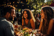 Friends joyfully dine and laugh outdoors in a summer restaurant 
