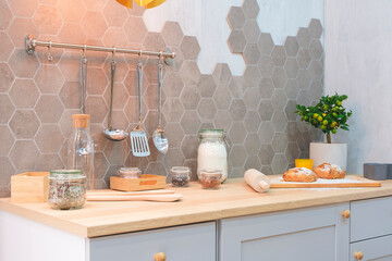 Poster - Modern kitchen interior with products on counter, Kitchen table with ingredients for cooking baking with blank place for your product