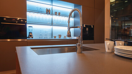 Aufkleber - Kitchen interior in a new home with a waterfall island, dark wood cabinets and stainless steel appliances.