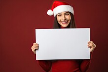 Beautiful Young Woman Wearing A Santa Claus Hat Holding A White Poster With Empty Space For Text.