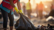 © B & G Media - Close-up of a young volunteer, emphasizing global pollution concerns while cleaning up trash.Pollution Concept