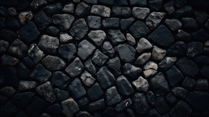 masonry of rough gray stones of various shapes and shades on the pavement. Beautiful background and surface texture of stone road 