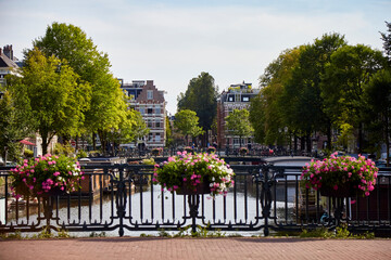 Sticker - View on a canal from a bridge with flowers on the fence, selective focus