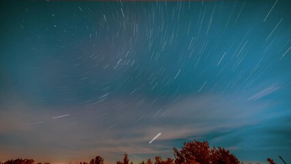 Poster - night sky with clouds over a sleeping city time lapse