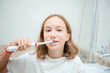 © Олеся Болтенкова - Dental hygiene. Happy little blonde girl brushing her teeth. Healthy concept