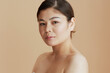 © Alliance - Portrait of young asian female looking in camera