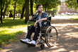 © Raisa Kanareva - A young man in a wheelchair talks on the phone.