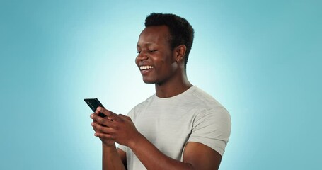 Poster - man, smile and texting on phone in studio by blue background for networking, message and social medi
