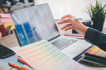 Fototapete - Graphic designer architects who work with laptops and color comparison tables for design work..