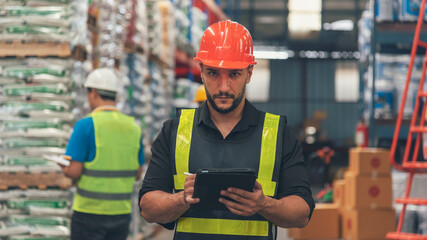 Warehouse management logistics team counting checking products on inventory shelf. Hispanic men worker check stock control in distribution storage. Teamwork shipment worker checklist quality control