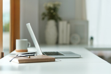 Wall Mural - Modern workplace with laptop glasses, financial document and pencil holder.