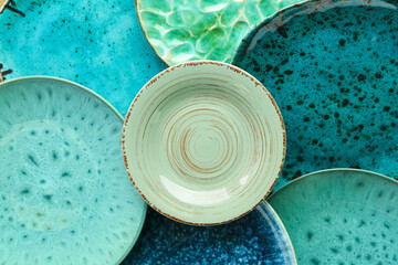 Wall Mural - Closeup view of turquoise ceramic plates as background