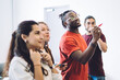 © BullRun - Young coworking students drawing plan on glass wall