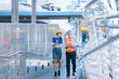 © Exnoi - Professional engineer man and businesswoman manager leader wearing helmet and walking in city talking and discussing for work. Building, facility, factory, industry big project, Construction teamwork.