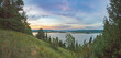 Sunrise on the river bank sun through the trees, beautiful clouds panoramic view.