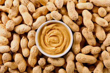 Wall Mural - Peanut butter in bowl with peanut background