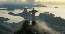 Aerial Above Christ Statue On The Top Of Corcovado Hill With Botofago Bay And Sugar Loaf Mountain In Background, Brazil