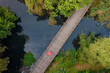 Red umbrella on the wooden path - top-down view