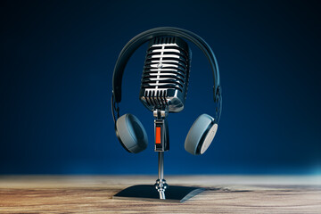 Poster - Close up of steel vintage singing vocal microphone on wooden surface and blue background. 3D Rendering.
