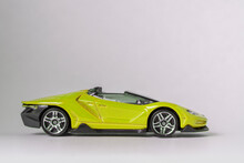 Sideview Of Yellow Toy Model Convertible Supercar On A White Background