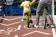 © GDM photo and video - man and little boy cyclists on bike lane in city street in summer time