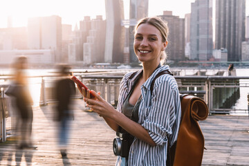 Wall Mural - Half length portrait of cheerful woman tourist with instant camera on neck