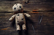 A voodoo doll is pinned with multiple needles and rests on a rustic wooden surface