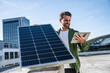 © Westend61 - Engineer holding digital tablet and solar panel on sunny day